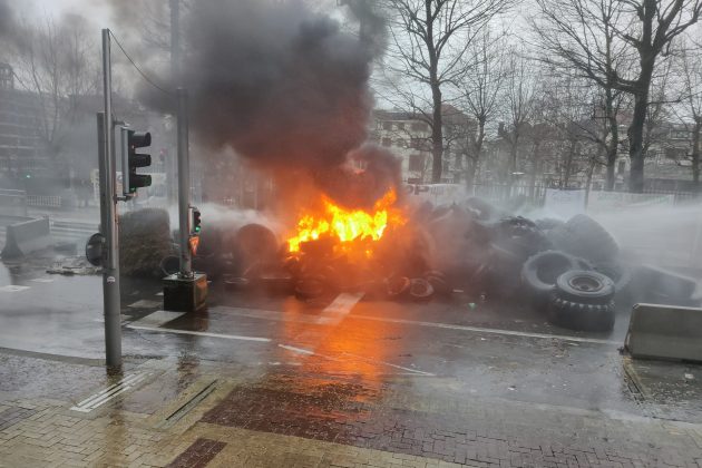 Fires blazed outside EU institution buildings on Monday, February 26, as the EU-wide farmers' protests returned to the streets of Brussels. (Peter Caddle/Brussels Signal)