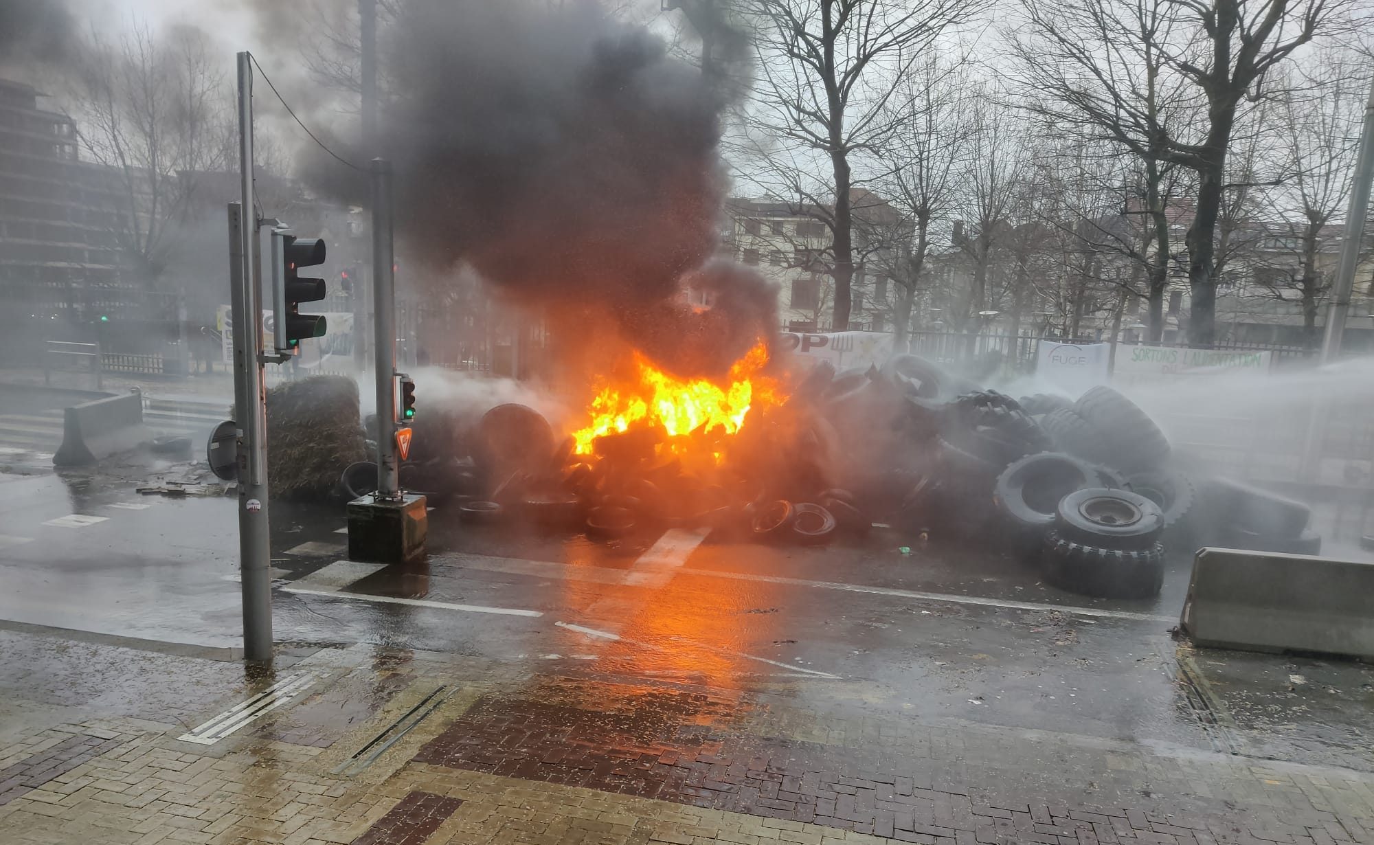 Fires blazed outside EU institution buildings on Monday, February 26, as the EU-wide farmers' protests returned to the streets of Brussels. (Peter Caddle/Brussels Signal)