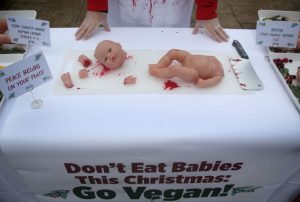 A PETA climate-activist stall in a UK market before Christmas. The group stated: 'All animals are someone's babies regardless of species', urging consumers to choose a vegan option instead. (Martin Pope/Getty Images)