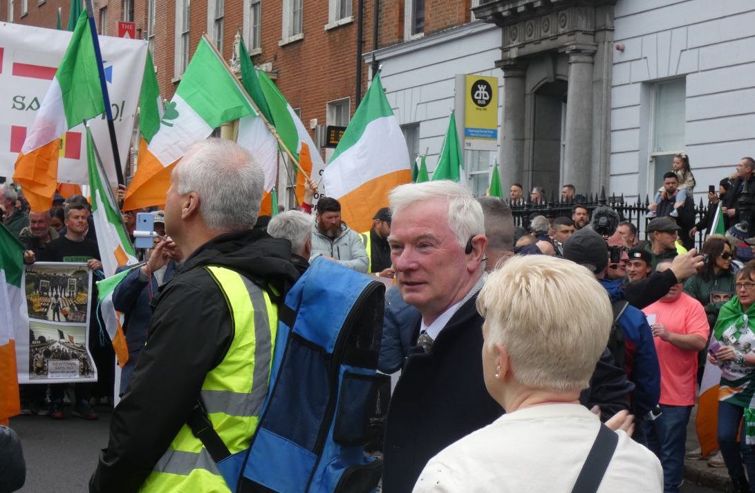 MEP candidate Malachy Steenson at migration protest (Anonymous).