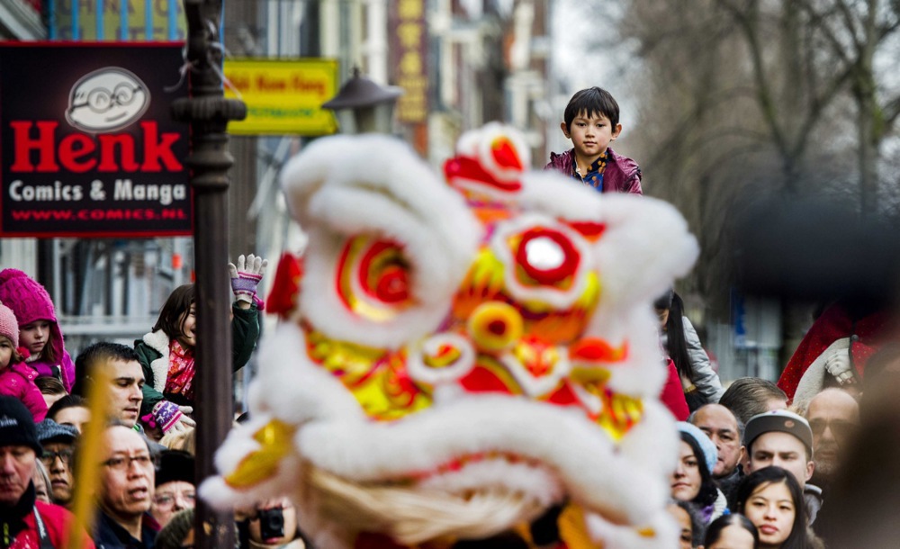 Inhabitants of Amsterdam celebrate the New Year with a traditional lion dance in the center of the Chinese area in Amsterdam. EPA/REMKO DE WAAL