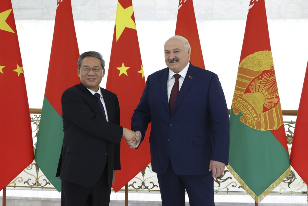 A handout photo made available by the Press Service of the President of the Republic of Belarus shows Belarusian President Alexander Lukashenko (R) and Chinese Premier Li Qiang (L) shaking hands during a meeting in Minsk, Belarus, 22 August 2024. (EPA-EFE/BELARUS PRESIDENT PRESS SERVICE POOL HANDOUT)