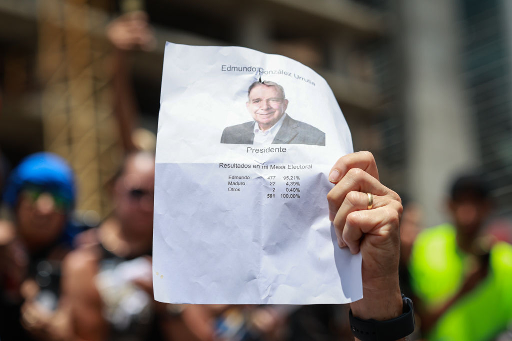 A supporter shows a poster with the face of Edmundo Gonzalez in Caracas, Venezuela. (Jesus Vargas/Getty Images)