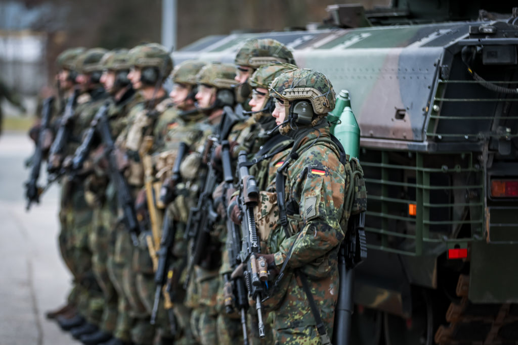 German soldiers stand outside a Puma IFV, perhaps wondering if eco-friendly powder has glued up the engine, if the air conditioning is working, and if the driver seat can fit a pregnant soldier (Photo by Leonhard Simon/Getty Images)