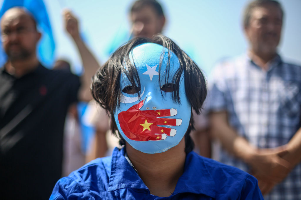 A Uyghur protests abroad. If a Uyghur protests at home in China, he could end up a slave worker or a prison inmate. Or dead. (Photo by Hakan Akgun/dia images via Getty Images)