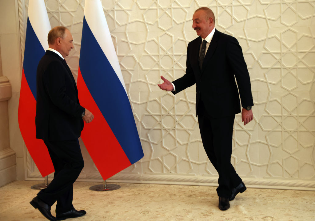 Azeri President Aliyev welcomes Putin with a big smile. Why not? The West tries not to buy oil from Putin, so it pretends Aliyev is cleaner. Just smile, and clear the corpses. (Photo by Contributor/Getty Images)