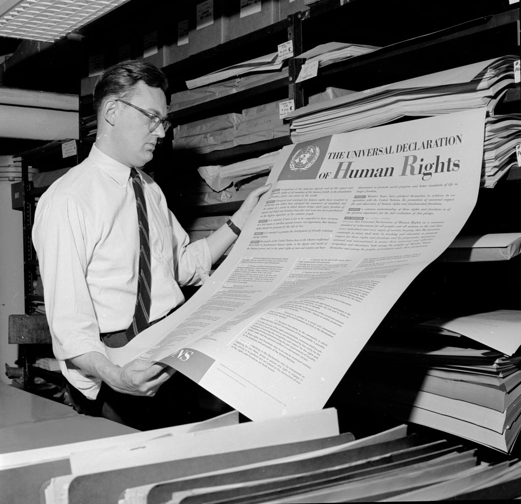 Where the stink started? A man examines an early copy of the UN Universal Declaration of Human Rights, 1948 (Photo by Three Lions/Hulton Archive/Getty Images)