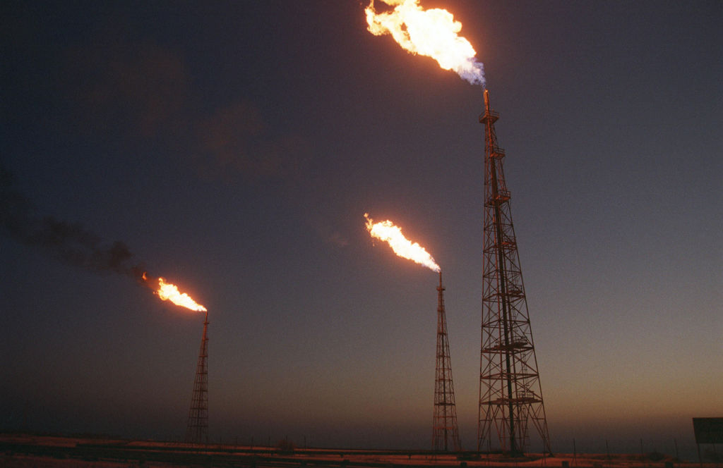 Unwanted natural gas being burned off at an oil field on Iran's Kharg Island. Meanwhile Europe has whimsies about solar and wind, (Photo by Kaveh Kazemi/Getty Images)