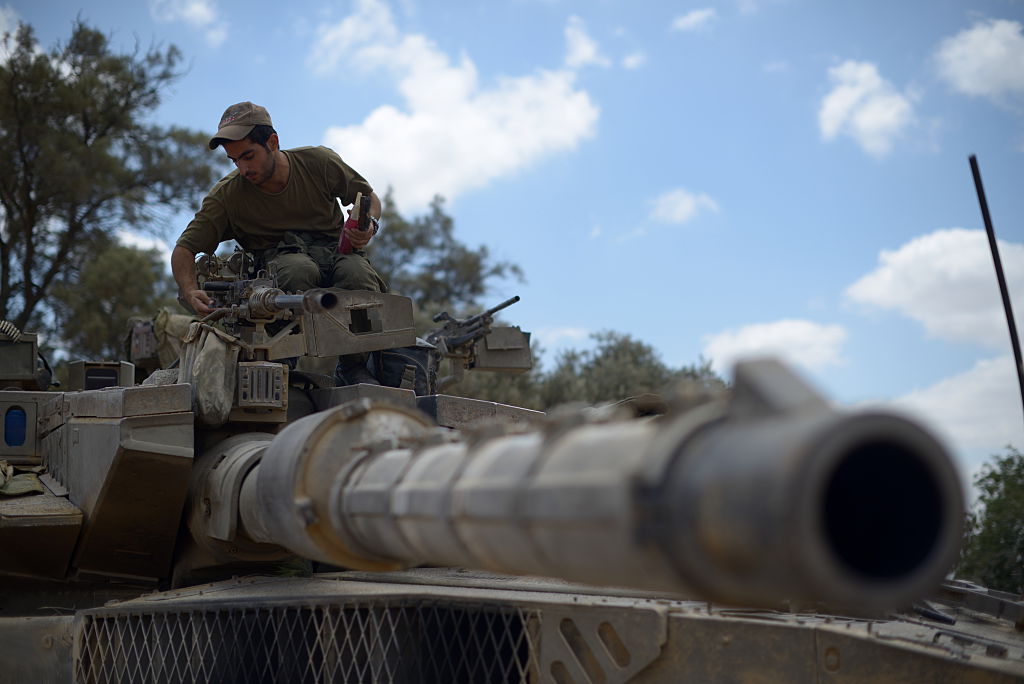 An Israeli soldier stands atop a Merkava tank for which German firm Renk provides parts. (NurPhoto/Corbis via Getty Images)
