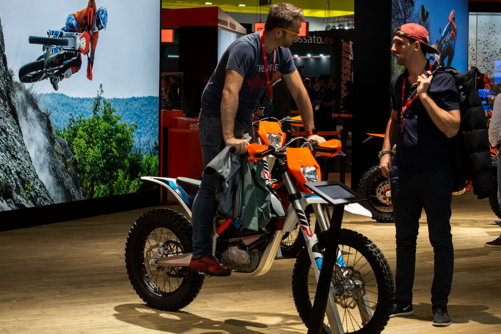 A man tries a motorcycle manufactured by Austrian company KTM. (Emanuele Cremaschi/Getty Images)