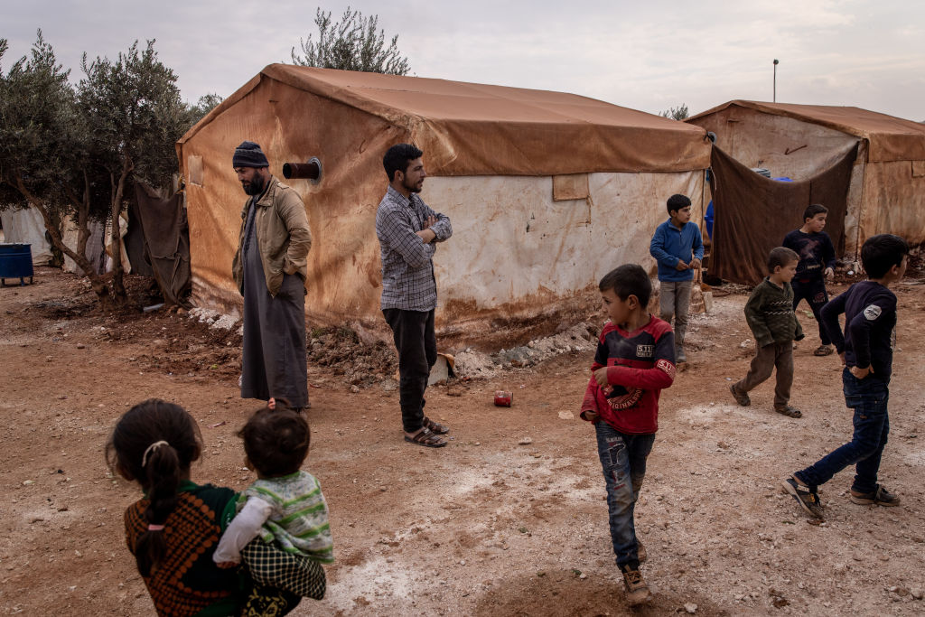 Displaced Syrians wait for food aid. (Chris McGrath/Getty Images)
