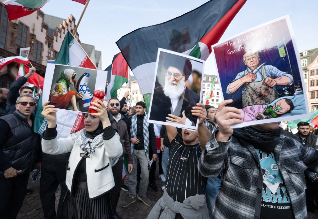 A demonstration organized by the Islamic Religious Community of Hesse (IRH) took place at Römerberg, in Frankfurt on March 8, drawing between 650 and 800 participants, according to police estimates. The rally, titled “For Peace and International Law,” coincided with International Women's Day.(Photo by BORIS ROESSLER / dpa Picture-Alliance via AFP)