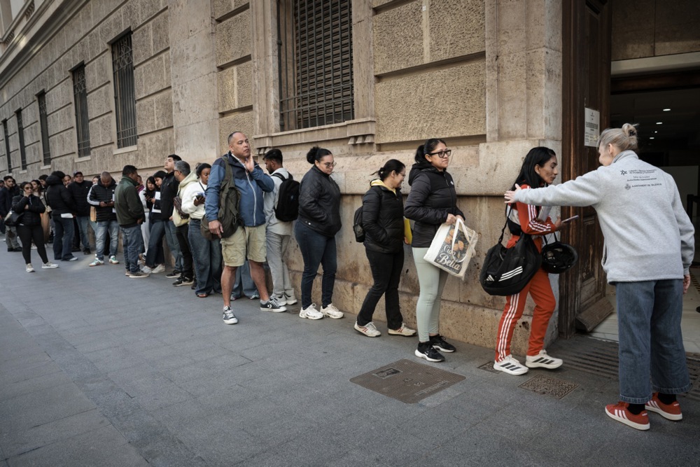 On day one alone, 13,500 applications poured in through the Spanish government’s “extraordinary regularisation” scheme.EPA/BIEL ALINO